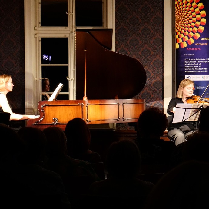 Konzertlesung mit Geigerinnen und Pianistin auf der Bühne (vergrößerte Bildansicht wird geöffnet)