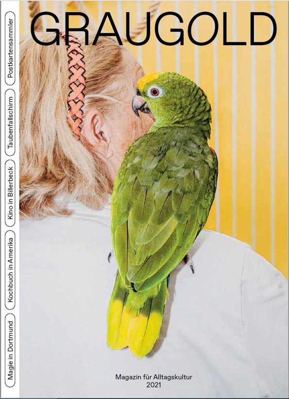 Magazincover Graugold - Ausgabe 2021. Frau von hinten mit Papagei auf der Schulter.